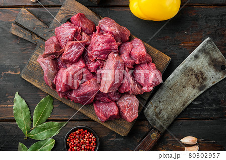 Beef casserole or goulash ingredients with sweet bell pepper, on old dark wooden table , top view flat lay 80302957