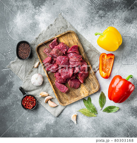 Irish raw Beef Stew Recipe ingredients with sweet bell pepper, on gray stone background, top view flat lay, square format 80303168
