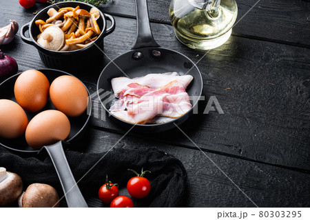 Breakfast egg ingredients, on black wooden table background, top view flat lay , with space for text copyspace 80303295