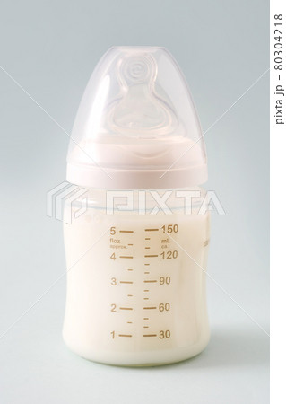 Baby bottle and milk on blue background Baby bottle and milk on blue background 80304218