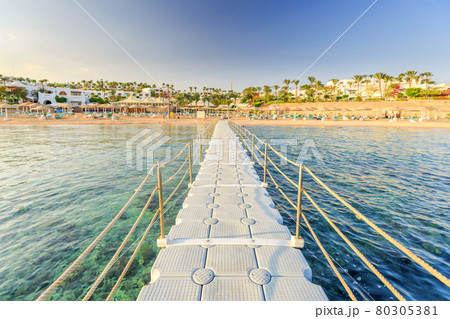 Pontoon with handrails through coral reef to the sea 80305381