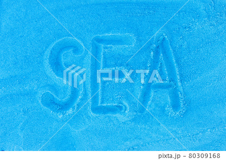 The word sea is written on a beach sand blue background. Sign or symbol of the sea concept 80309168
