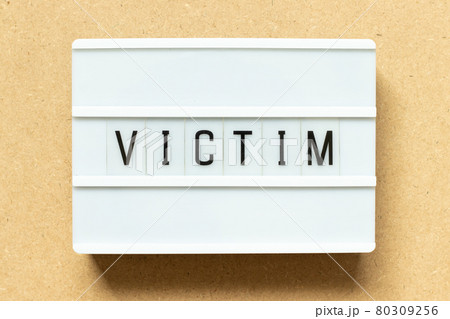 Lightbox with word victim on wood background Lightbox with word victim on wood background 80309256