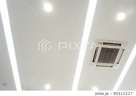 Lighting and ceiling mounted air conditioner on the modern office ceiling Lighting and ceiling mounted air conditioner on the modern office ceiling 80312227