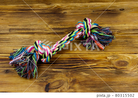 Colorful rope toy for dog on wooden background 80315502