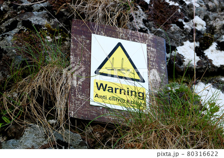 Anti Climbing Spikes Warning Sign on a Stone Castle Wall Anti Climbing Spikes Warning Sign on a Stone Castle Wall 80316622