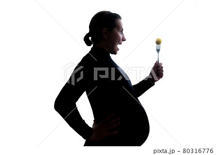 Young pregnant woman eating holding fork on a white background 80316776