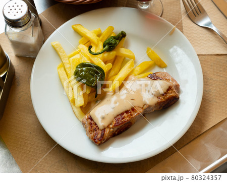 Grilled pork with potato, pepper and sauce 80324357