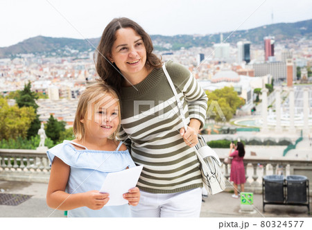 Woman with daughter at the street among architecture at Barcelona 80324577