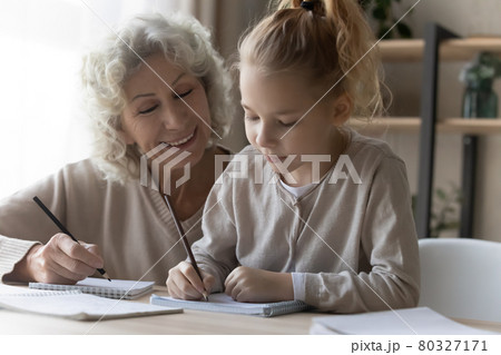 Friendly old female private tutor interact with preteen girl pupil Friendly old female private tutor interact with preteen girl pupil 80327171