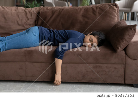 Exhausted Indian woman sleep on couch at home 80327253