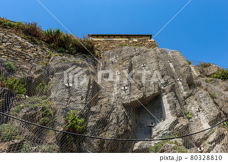 Rockfall Barrier with Wire Mesh on the Cliff - Cinque Terre Liguria Italy Rockfall Barrier with Wire Mesh on the Cliff - Cinque Terre Liguria Italy 80328810