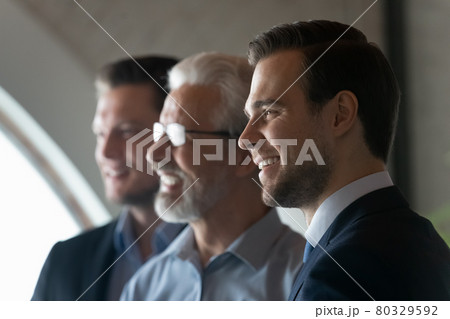 Happy young male business leader looking away and smiling Happy young male business leader looking away and smiling 80329592