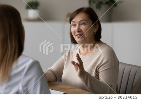 Positive elder patient visiting doctor, consulting about healthcare problems Positive elder patient visiting doctor, consulting about healthcare problems 80334015