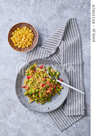 Quinoa salad with green beans, corn, red bell peppers, peas and soybeans. Useful vegetable mix 80334629