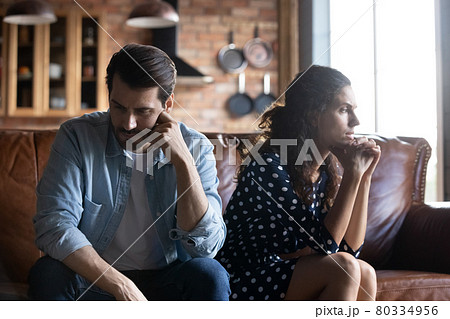 Angry young husband and wife sitting together, hating, ignoring 80334956