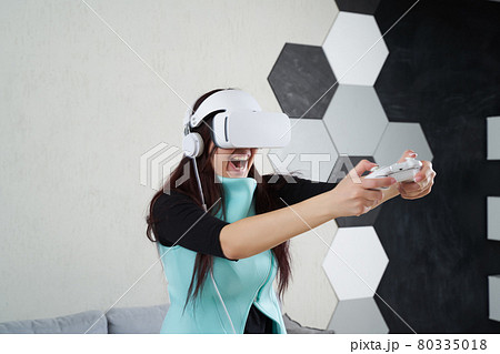 Woman with virtual reality headset is playing game. 80335018