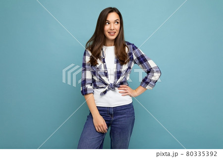 Photo portrait of young beautiful smiling hipster brunette woman in trendy blue and white shirt and Photo portrait of young beautiful smiling hipster brunette woman in trendy blue and white shirt and 80335392