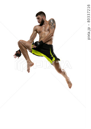 Professional male MMA boxer in motion isolated on white studio background. Fit muscular caucasian athlete fighting. 80337216