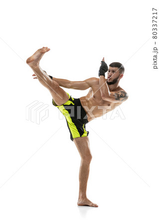 Professional male MMA boxer in motion isolated on white studio background. Fit muscular caucasian athlete fighting. 80337217