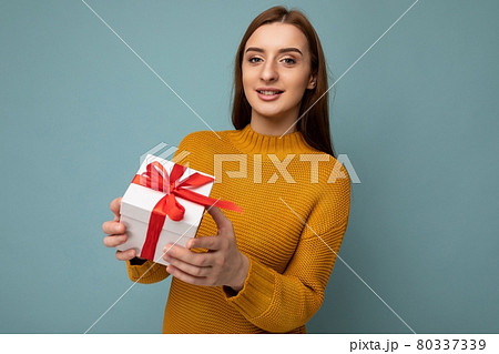 Beautiful happy young brunette woman isolated over colourful background wall wearing stylish casual 80337339