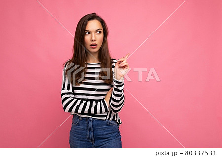Shot of young positive happy thoughtful attractive brunette woman with sincere emotions wearing Shot of young positive happy thoughtful attractive brunette woman with sincere emotions wearing 80337531
