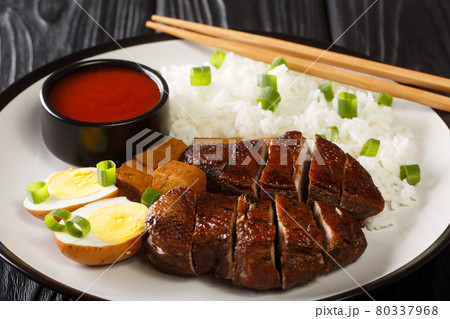Chinese Braised Duck served with rice, eggs and tofu close-up in a plate. horizontal Chinese Braised Duck served with rice, eggs and tofu close-up in a plate. horizontal 80337968