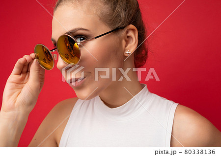Closeup photo of attractive sad thoughtful angry young blonde woman wearing everyday stylish clothes Closeup photo of attractive sad thoughtful angry young blonde woman wearing everyday stylish clothes 80338136