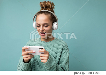 Photo shot of beautiful joyful smiling young female person wearing stylish casual outfit isolated 80338698