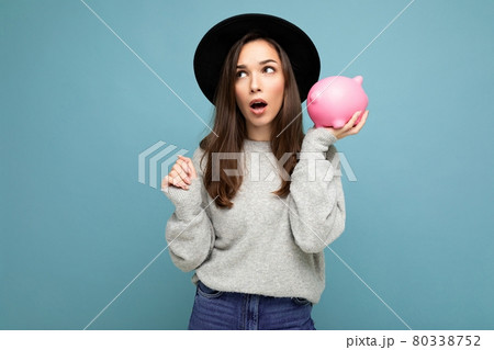 Portrait of astonished amazed young nice attractive woman with dark hair wearing stylish gray 80338752