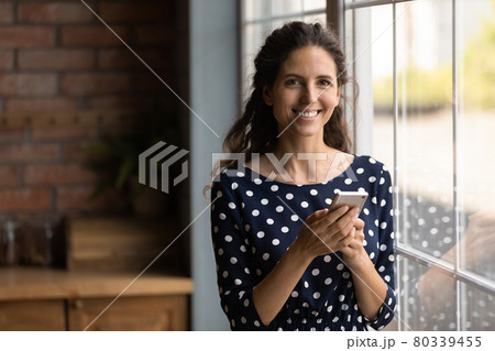 Happy millennial Hispanic woman using online virtual service Happy millennial Hispanic woman using online virtual service 80339455