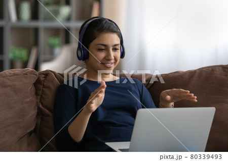 Smiling Indian woman talk on webcam call on computer Smiling Indian woman talk on webcam call on computer 80339493