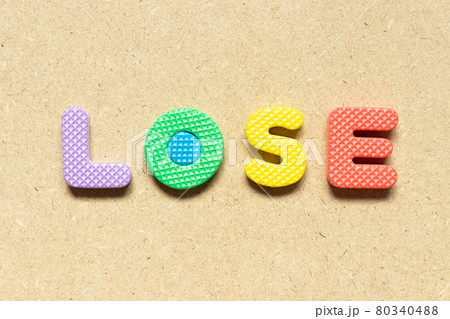 Foam alphabet letter in word lose on wood background Foam alphabet letter in word lose on wood background 80340488