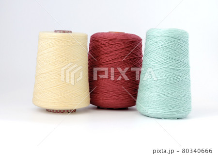 Multicolors bobbins of wool yarn for hand and machine knitting on a white background 80340666