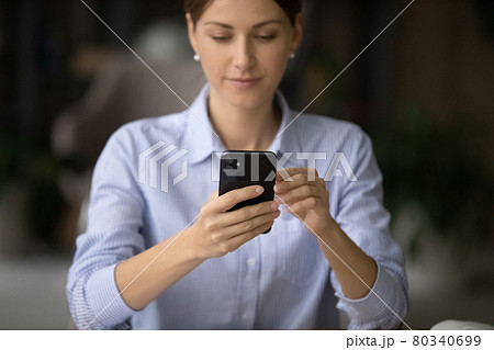 Young business woman using smartphone application in office. Young business woman using smartphone application in office. 80340699
