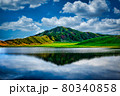 Beautiful green mountains in front of a large lake 80340858