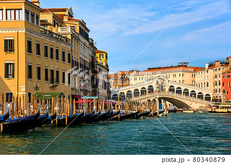 Great view of famous bridge of Rialto or ponte di Rialto over Grand Canal, Venice, Italy. Iconic travel destination of UNESCO world heritage city Great view of famous bridge of Rialto or ponte di Rialto over Grand Canal, Venice, Italy. Iconic travel destination of UNESCO world heritage city 80340879