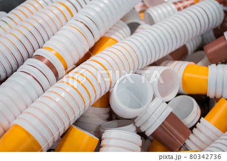 Many stacks of empty orange and brown plastic cups at warehouse - close up Many stacks of empty orange and brown plastic cups at warehouse - close up 80342736