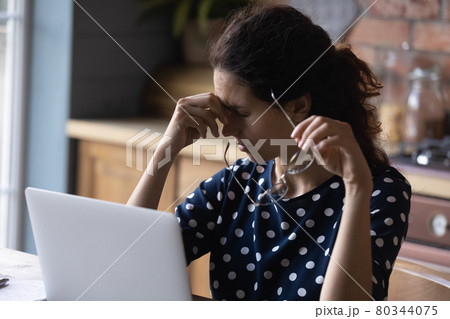 Tired woman working from home, using computer too long 80344075