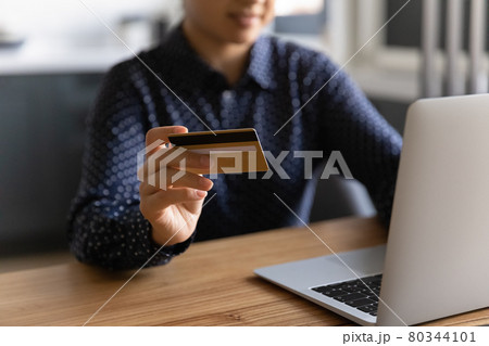 Millennial woman shopping online from home, using laptop 80344101
