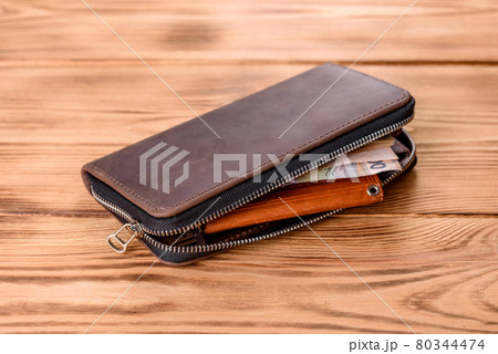 Beautiful leather brown purse made of leather to store paper money Beautiful leather brown purse made of leather to store paper money 80344474