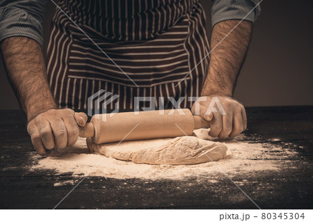 Male hands knead the dough. Male hands knead the dough. 80345304