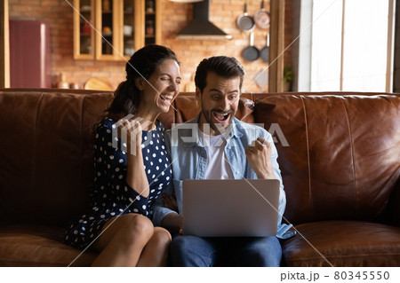 Overjoyed excited millennial couple getting good news Overjoyed excited millennial couple getting good news 80345550