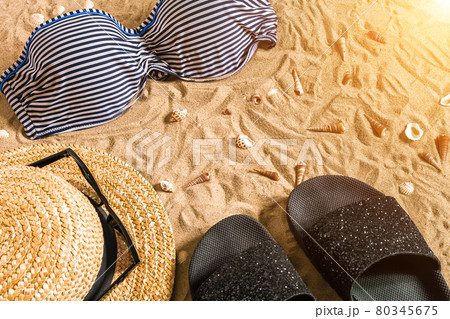Summer bikini and accessories stylish beach set, Beach bikini summer outfit and sea sand as background, Top View, Concept Summer bikini and accessories stylish beach set, Beach bikini summer outfit and sea sand as background, Top View, Concept 80345675
