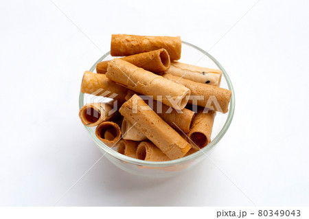 Thai crispy coconut rolls in glass bowl on white background. Thai crispy coconut rolls in glass bowl on white background. 80349043