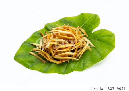 Sliced fingerroot on green leaves on white background. 80349091