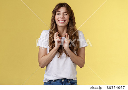 Excited happy cheerful optimistic girl peeking nervously awaiting results look one eye camera hopeful smiling broadly cross fingers good luck intense praying dream come true fulfillment wish Excited happy cheerful optimistic girl peeking nervously awaiting results look one eye camera hopeful smiling broadly cross fingers good luck intense praying dream come true fulfillment wish 80354067