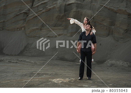 Happy young couple. Man piggybacking his girlfriend in summer Happy young couple. Man piggybacking his girlfriend in summer 80355043