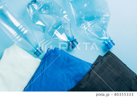 Polyester fiber synthetic fabrics eco-friendly textile recycled recyclable plastic bottles. Reuse recycling used bottles 80355333