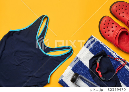 Flat lay summer pool accessories on a yellow background. Colorful beach wear. Flat lay summer pool accessories on a yellow background. Colorful beach wear. 80359470